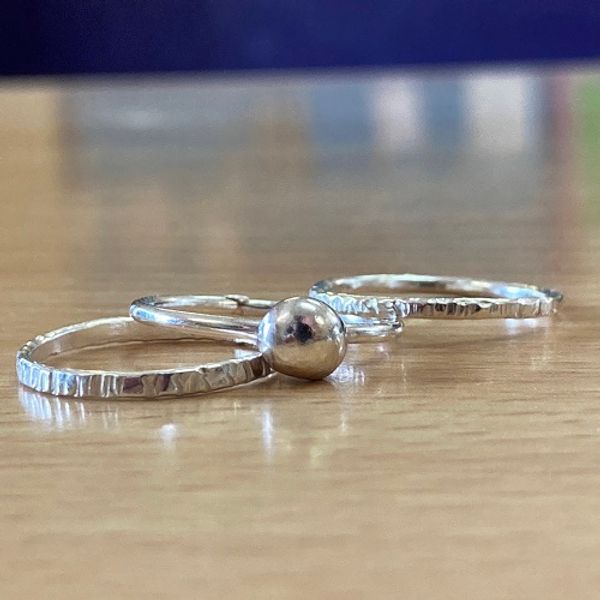 Two textured rings and one with a recycled silver bobble, created in class