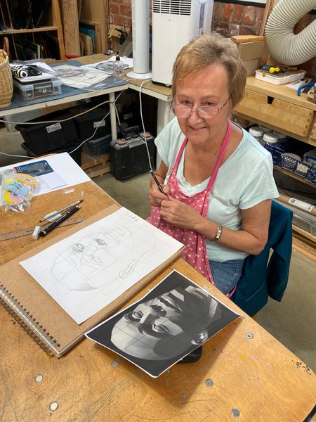 Student Maureen with one of her portraits
