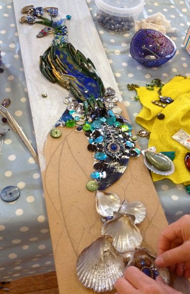 Mixed media mosaic using shells and jewellery with stained glass