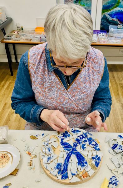 Debbie mosaicing her peacock