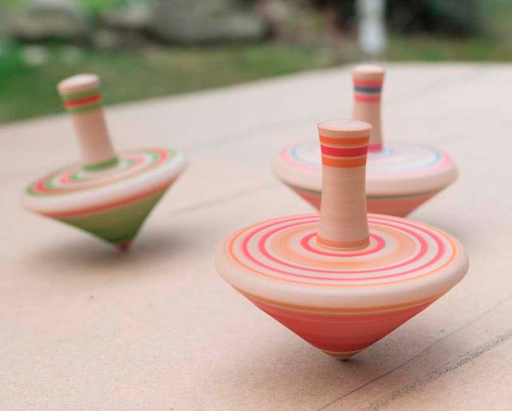 A trio of colourful wooden spinning tops.