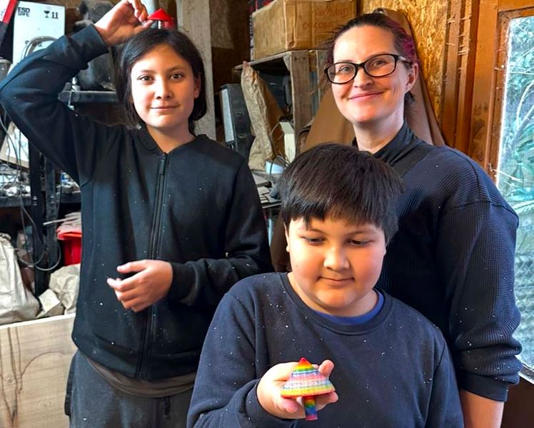 A happy family with their completed spinning tops.