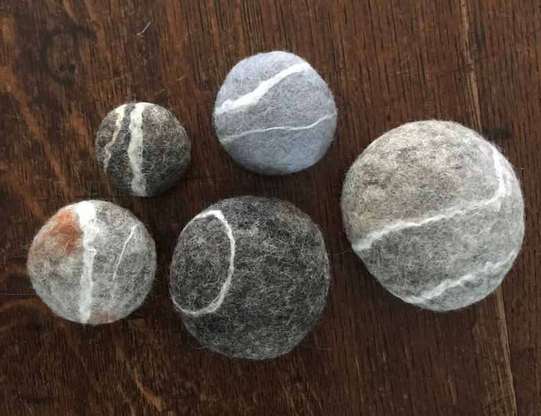 Set of five felted pebbles made with materials from the kit
