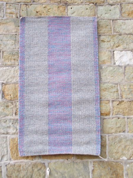 Block weave rug in blues and pinks.