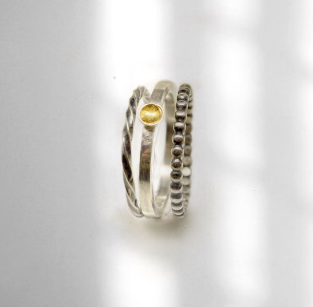 3 stacking rings using decorative silver wire and a concave brass disc.