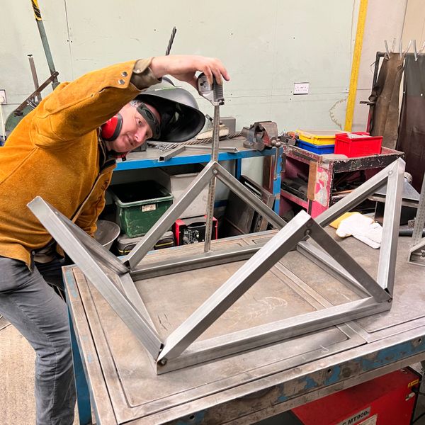 Student building a complex table legs structure