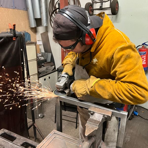 Student using an angle grinder