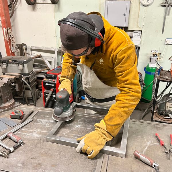 Student finishing welds on his frame