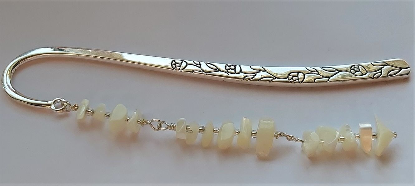 Moonstone has been addded through adding one moonstone at a time with silver wire and fastening them together individually creating a pretty unique design