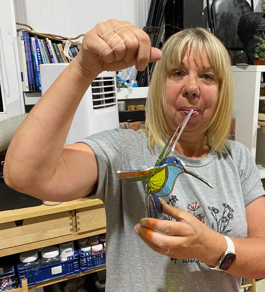 Alison with one of the two projects she made - 3d copper foiling hummingbird