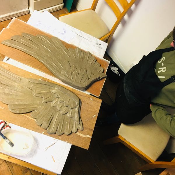 A pair of wings ready to dry, painted and be embellished