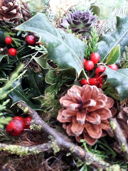 Cones, berries and evergreen foliage are a feature of this lovely arrangement