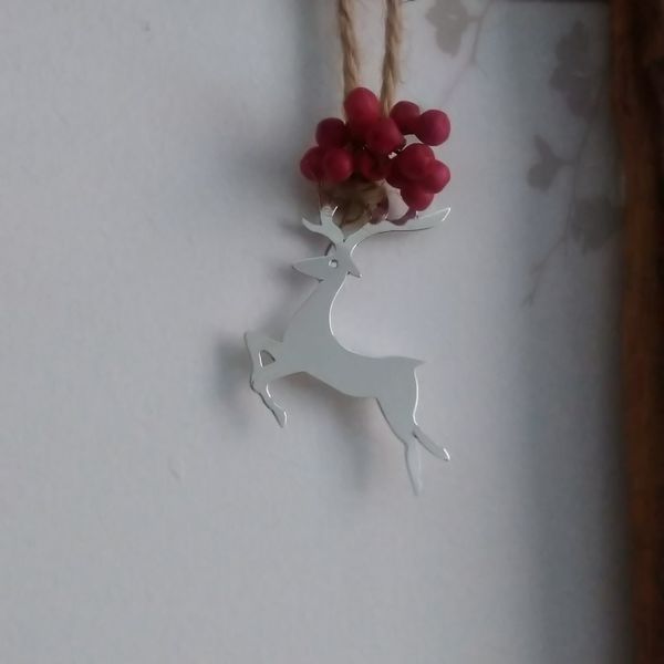 silver reindeer tree decoration. Berries added by participant.