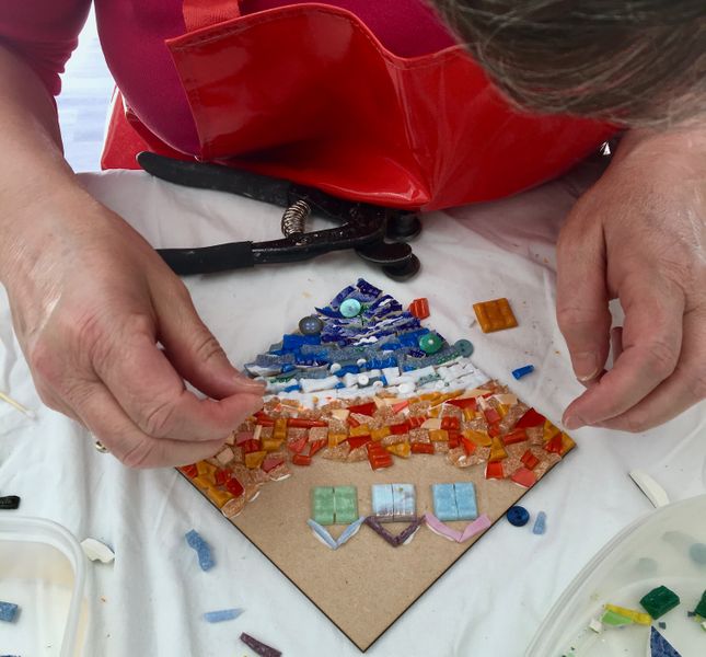 Catherine making a seaside mosaic using vitreous glass tiles
