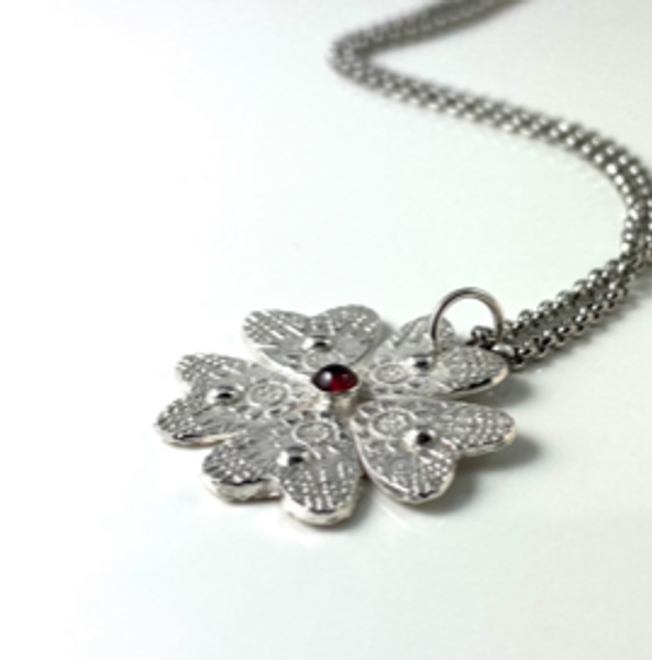 Stone set silver flower pendant
