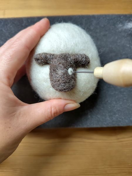 Needle felting in progress, with the needle attaching the eye. 