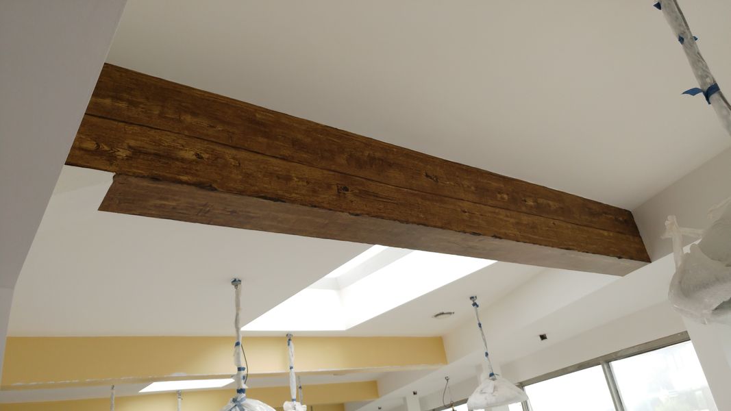 Structural beam with faux oak woodgrain finish