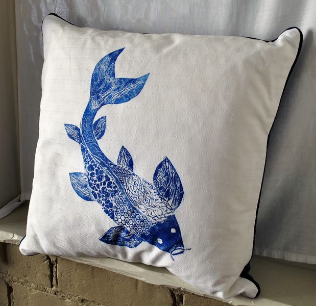 Front view of the blue hand-printed koi fish cushion.
