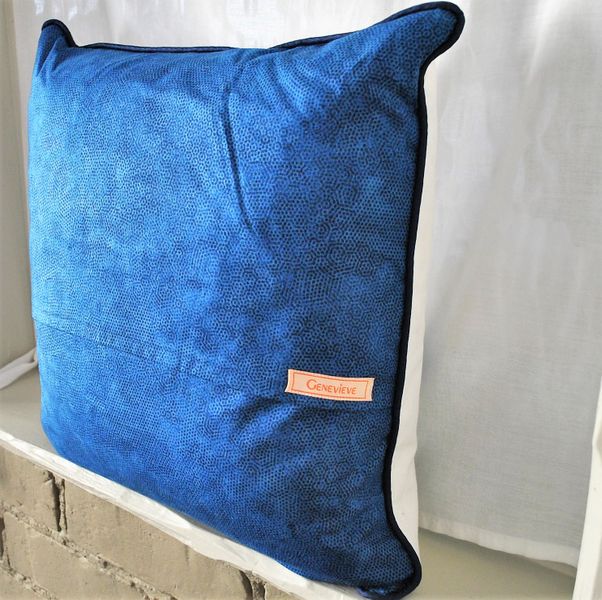 The back of the cushion, showing the blue cotton fabric and the back opening flap.