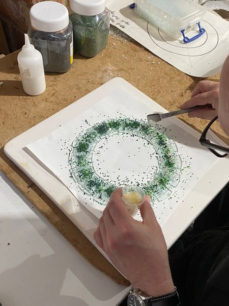 Adding coloured frit to the cut glass sections