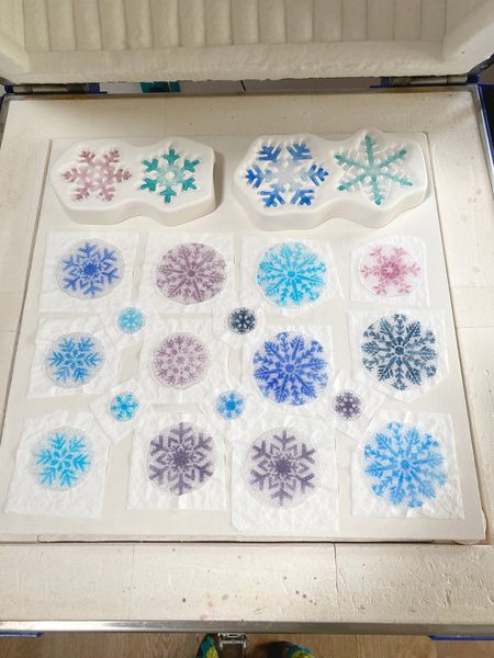 Examples of icy glass snowflakes in the kiln after firing.