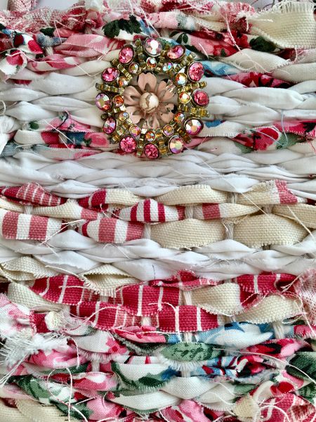 Close up of woven bag with a vintage brooch for decoration.