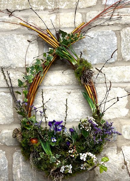 A beautiful handcrafted spring living wreath created from natural materials, bulbs and living plants 