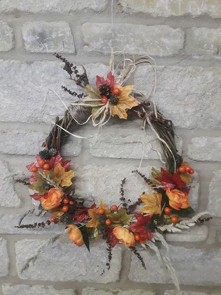 Fiery warm shades of reds and oranges are features of this wreath