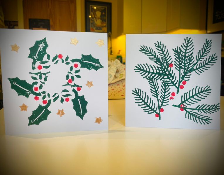 Examples of printed Christmas cards made by participants at a Christmas Paper workshop in December 2024