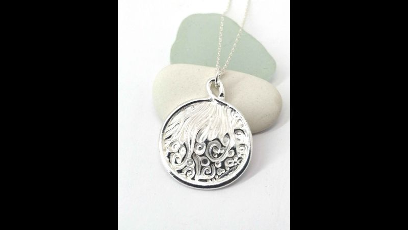 Textured and bordered silver pendant