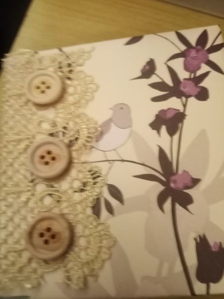 Front cover of a Junk Journal with lace paper and buttons