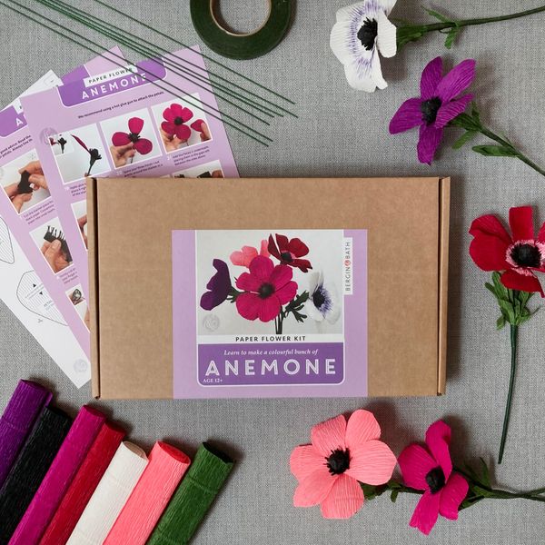 Bergin & Bath Paper flower kit - Anemone. Card box with colourful label, surrounded by the contents of the box.