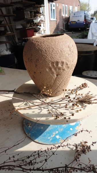 Impressing seed heads onto a coiled pot
