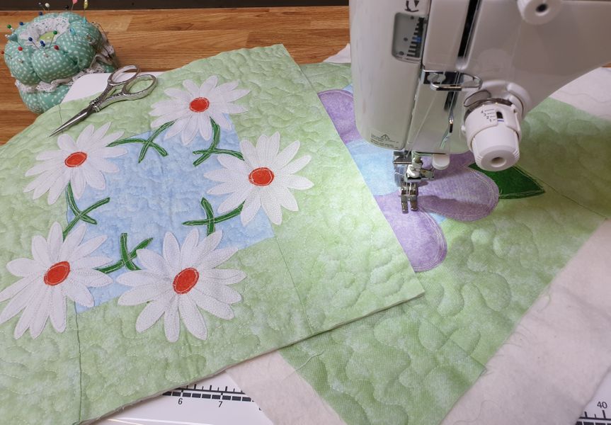 Two Appliqué blocks on the sewing machine.  The Daisy Chain pattern available as a download as part of the class