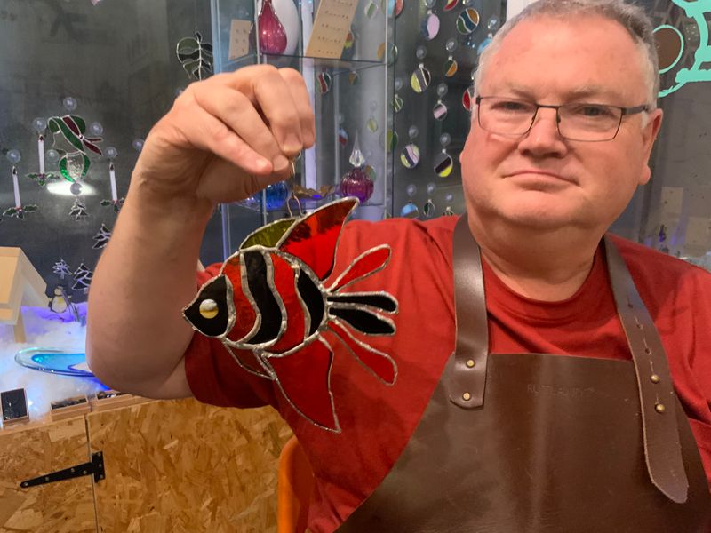 Happy glass course customer with his fish .