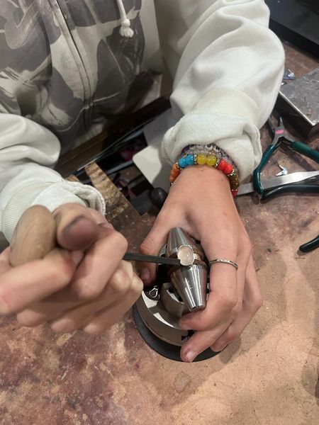 Woman setting stone on ring