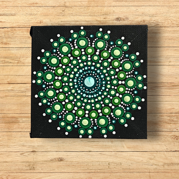 Dot mandala canvas using two layers of paint in greens