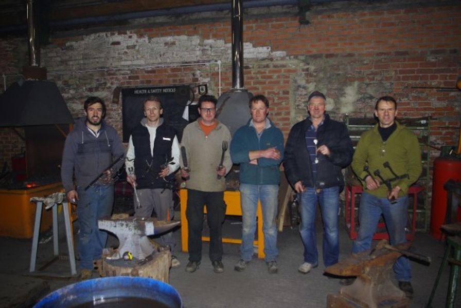 Students proudly hold up some of the work they made on our 5 day course in our Yorkshire forge