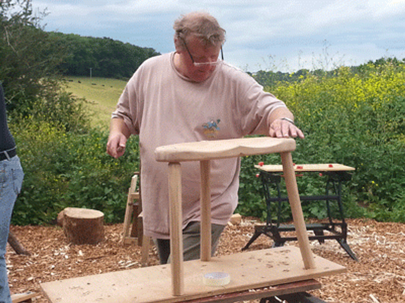 Dave adding finishing touches to his stool at the Devon Green Wood Centre