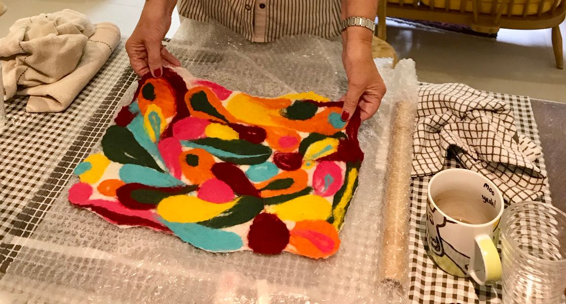 Participant in the process of fulling her abstract design