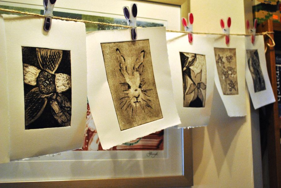 Hand-inked collagraph prints hanging to dry.