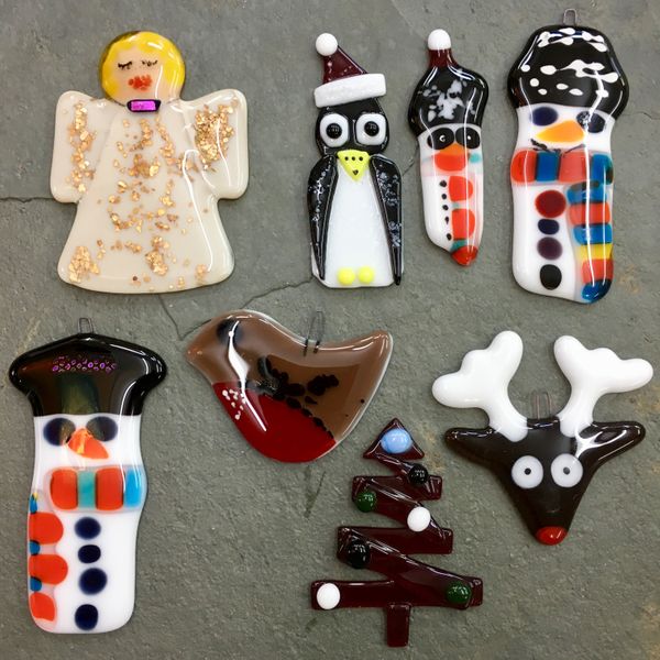 A collection of festive friends made by a student at Rainbow Glass Studios at the Christmas Course