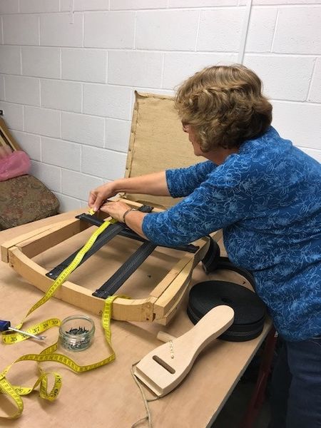 A student tackling a modern armless chair