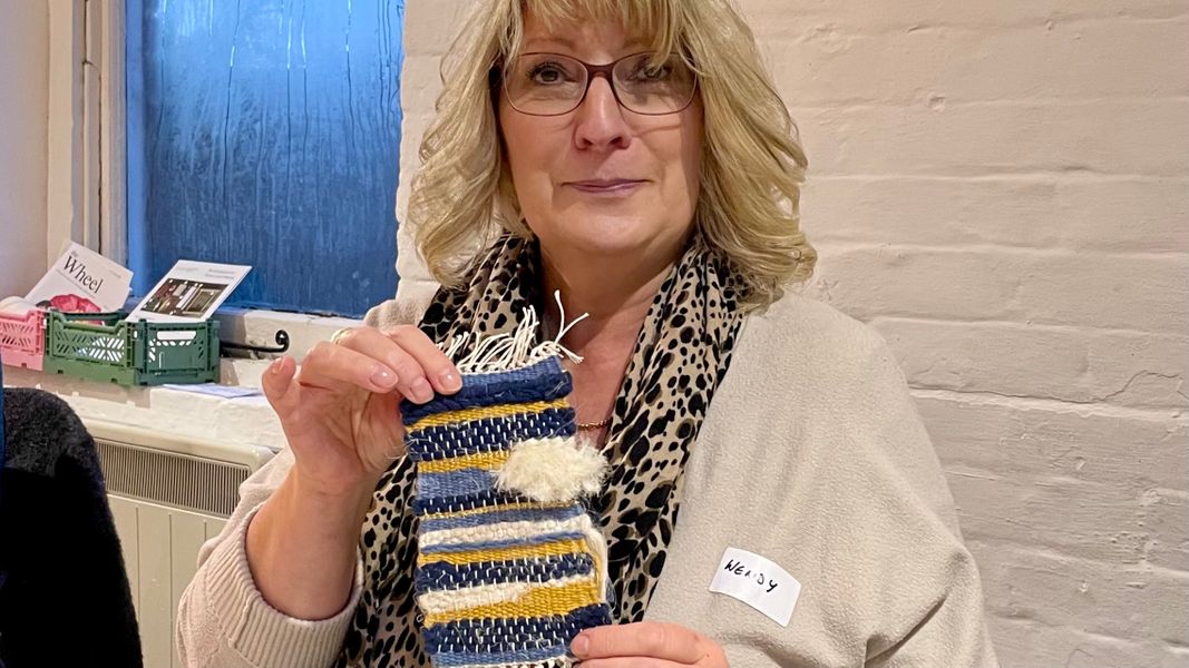 A student with her handwoven tapestry