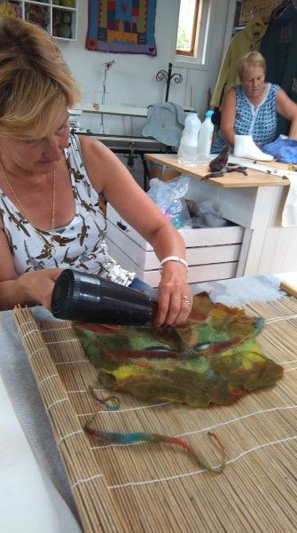 Student adding details to her Green Man in a beginners felt making course in the Forest of Dean.