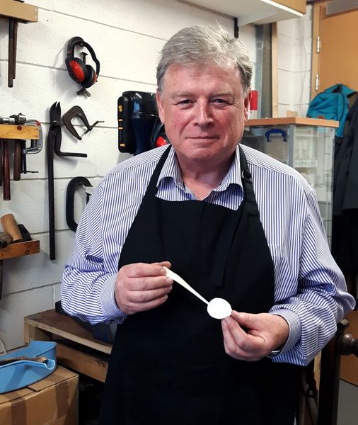 Des with his finished spoon.