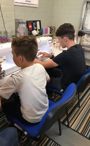 Children learn the basics of the sewing machine