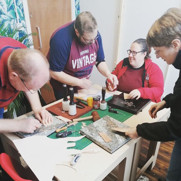 Students learning leatherwork