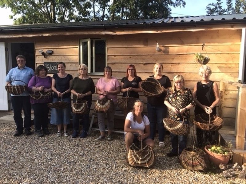 Course participants on completion of their circular frame baskets