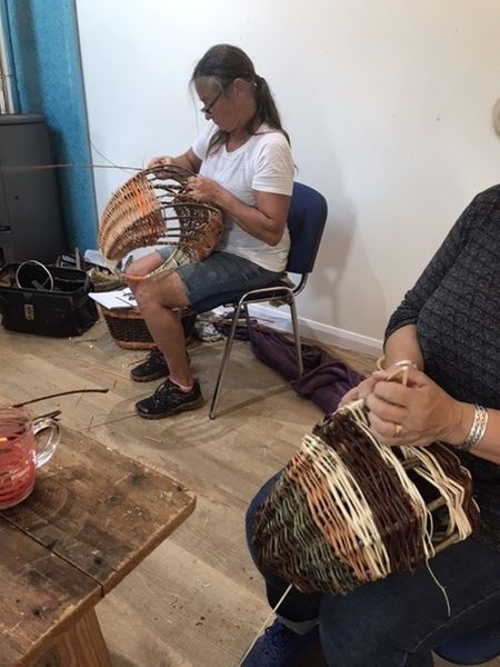 Students weaving circular frame baskets